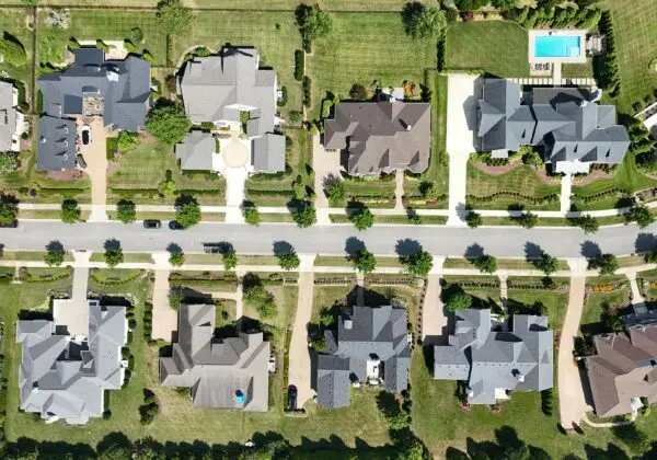 Overhead shot of beautiful homes in a suburban Tennessee neighborhood, showcasing lush greenery and modern architecture.