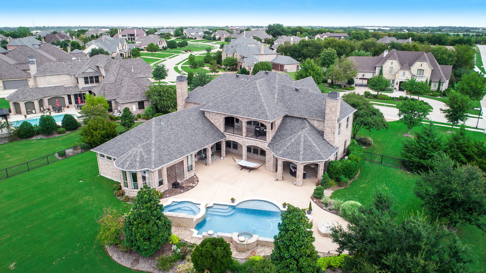Aerial view of a Texas home with pool and outdoor living space